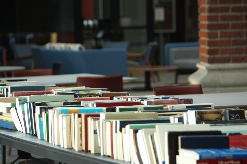 A table lined with books.