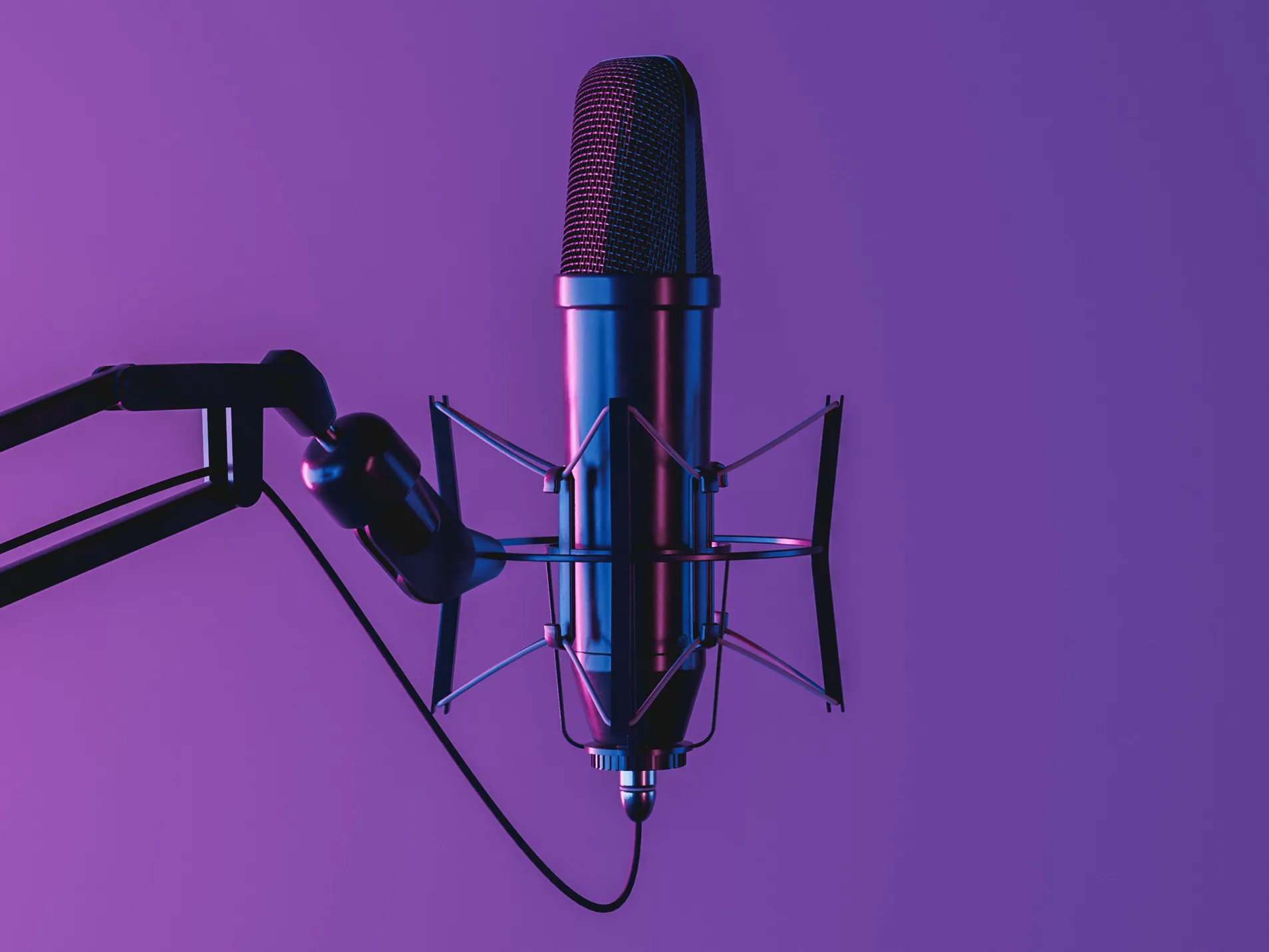 A microphone against a purple background. 